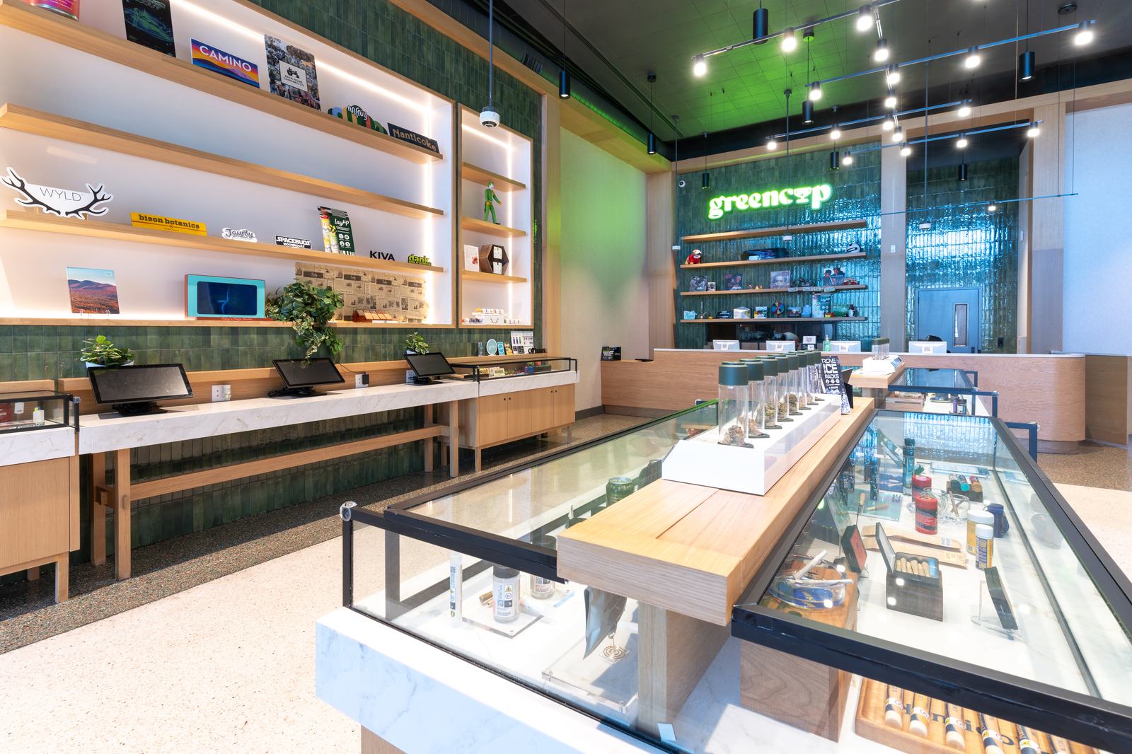 Green Cup dispensary — retail floor with green tile and illuminated display wall